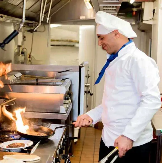 Sanford Estates Chef Created Meals, chef frying a dish.