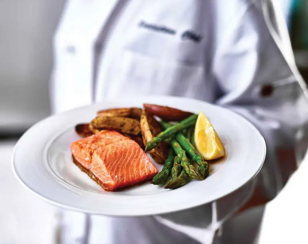 Sanford Estates Chef Created Meals, chef delivering a finished dish.