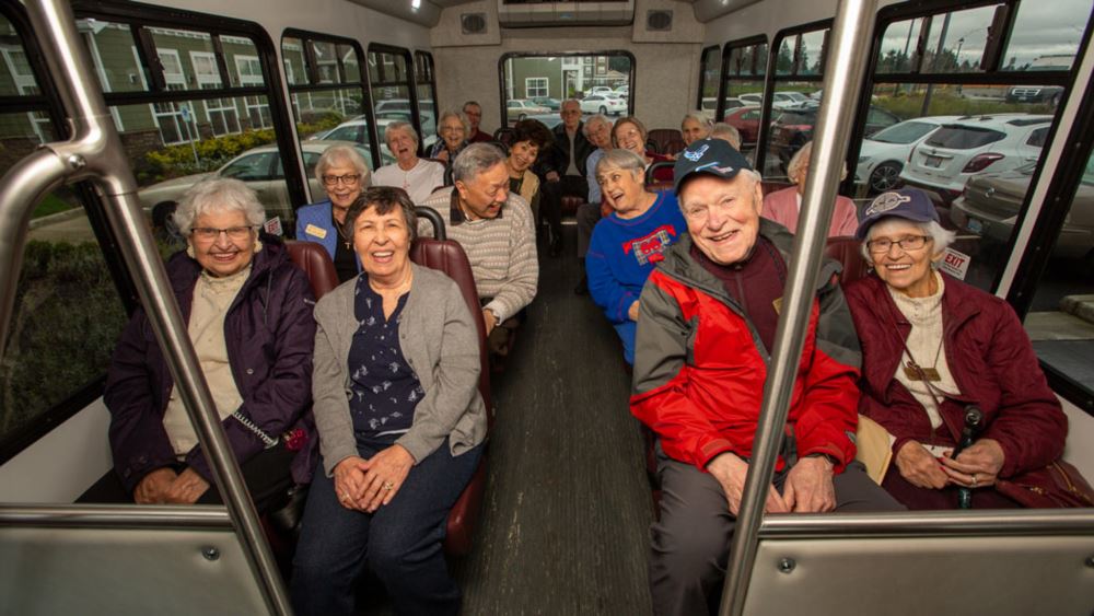 Sanford Estates happy seniors on a bus.