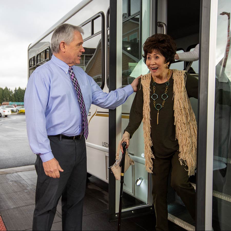 Sanford Estates helping lady off bus